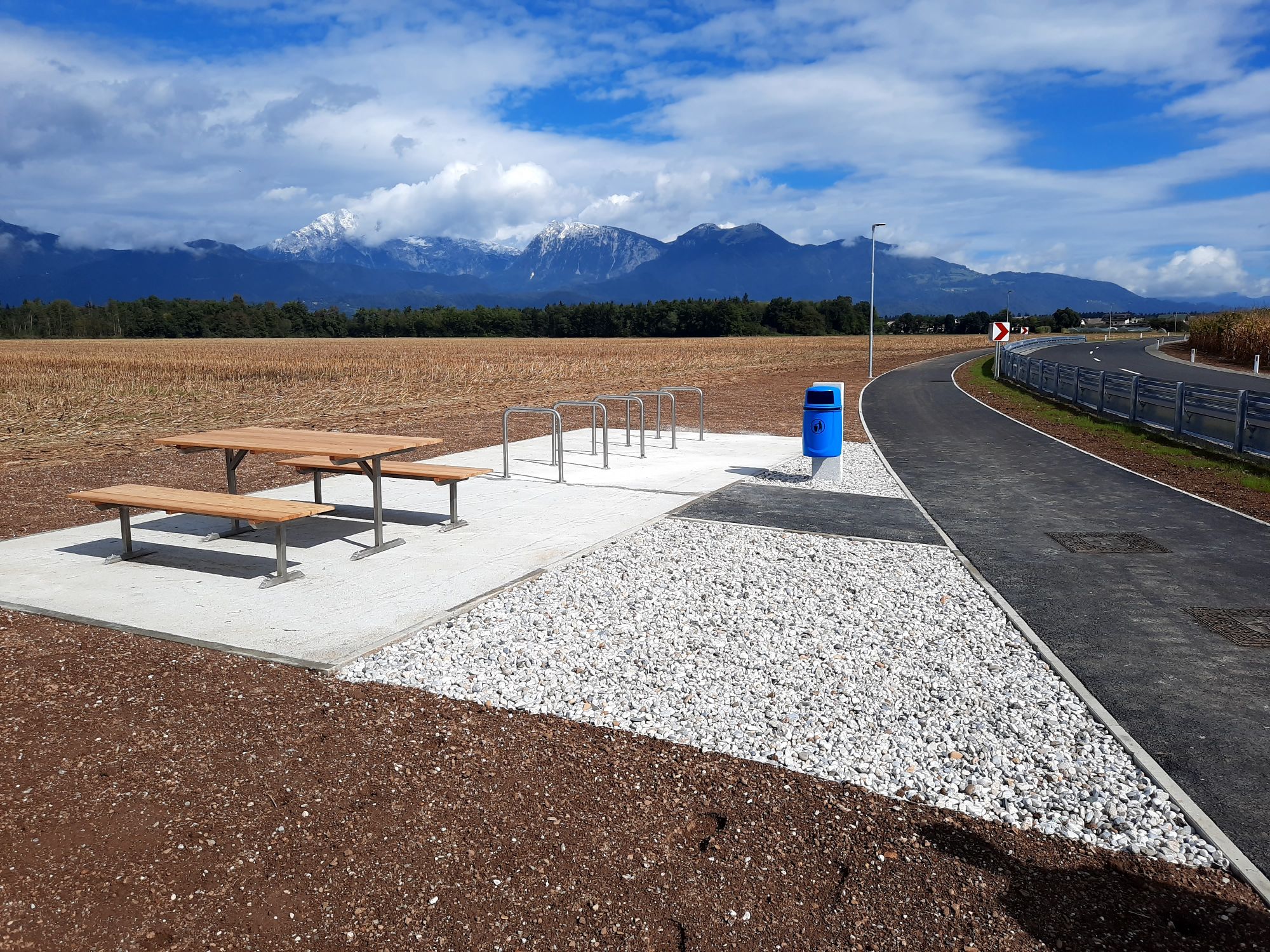 Newly constructed roadside rest area with mountains backdrop